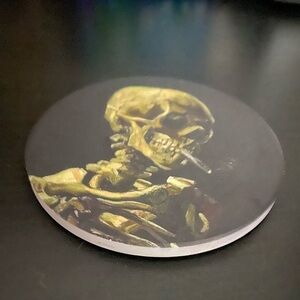 Skull of a Skeleton with Burning Cigarette Ceramic Coaster